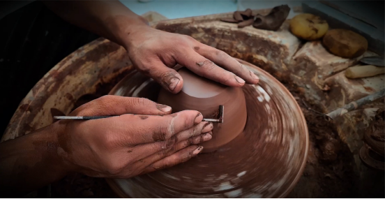 Five-colored pottery the artistic flower blossoming from the soil